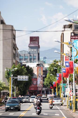a busy city street with cars and people riding motorcycles at Arsma Hotel in Hualien City