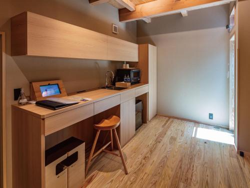 a kitchen with a desk with a computer on it at Hakata-no-Yado Tsurezure-Ann in Fukuoka