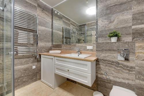 a bathroom with a sink and a shower at Luxury Willa Morska by Grand Apartments in Sopot