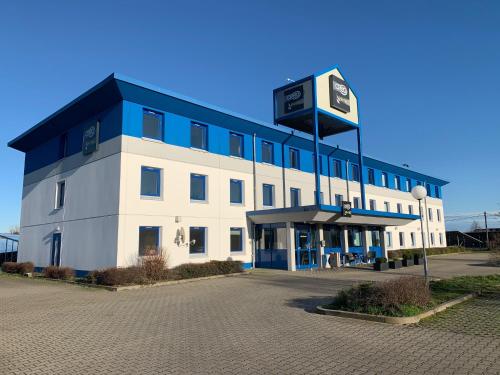 a large building with a clock on top of it at CREO Halle Peissen in Peißen