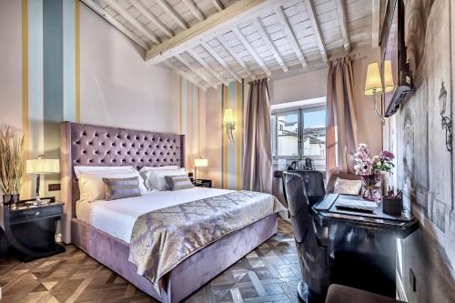 a bedroom with a large bed and a large window at Arte' Boutique Hotel in Florence