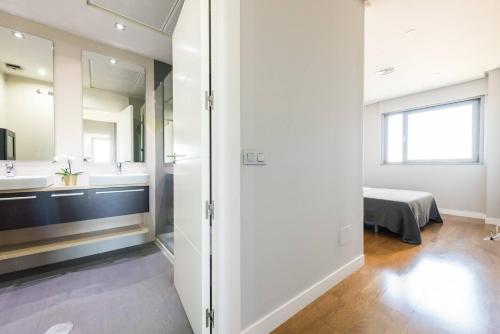 a bathroom with a sink and a mirror at JA Suites Madrid in Madrid