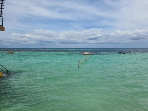 a large body of water with boats in it at L & M Hearthstones Lodge in Oslob