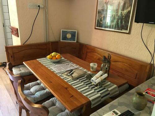 a wooden table with a bowl of fruit on it at Holiday Home 108 in Bezdan