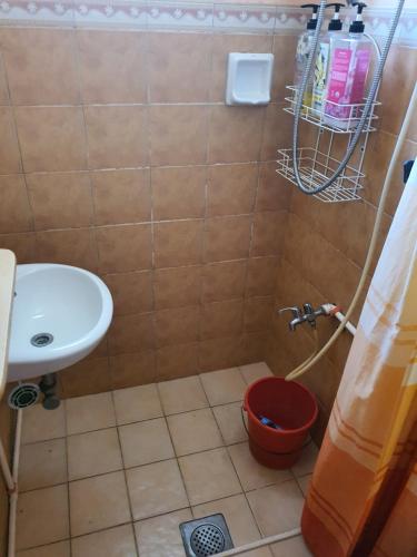 a small bathroom with a sink and a toilet at L & M Hearthstones Lodge in Oslob