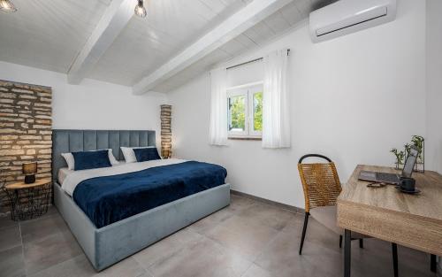 a bedroom with a bed and a table and a window at Villa Lemme in Rovinj