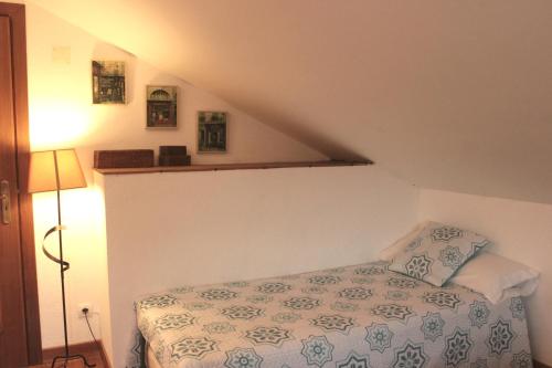 a bedroom with a bed in a attic at Quinta Sobral Prestige - Rustic House in Sobral de Monte Agraço