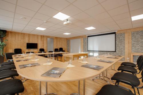 a large conference room with a large table and chairs at Le Castillan in L'Alpe-d'Huez