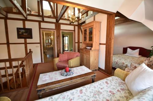 a room with two beds and a table at Pension zur Königlichen Ausspanne Dresden in Dresden