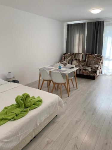 a room with two beds and a table and a couch at Summer Apartments Kabakum by Flat Manаger in Golden Sands