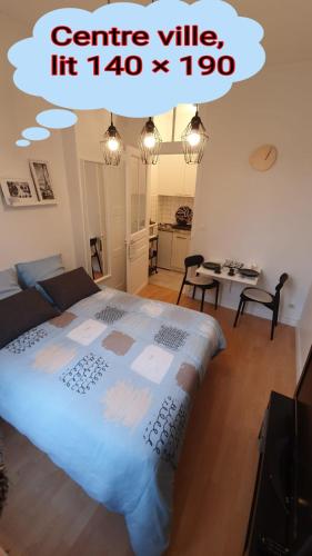 a bedroom with a large bed in a room at Le Galope, Appartement centre Compiègne in Compiègne
