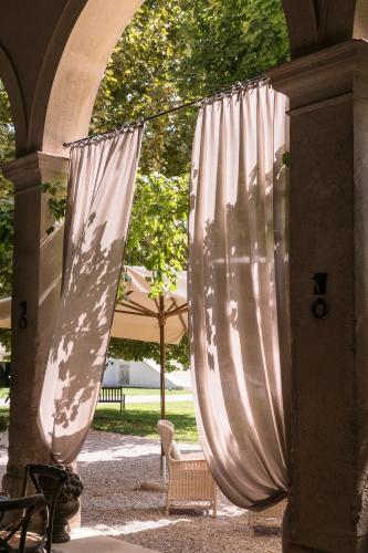 a pair of white curtains hanging from an archway at La Barchessa di Villa Pisani in Lonigo
