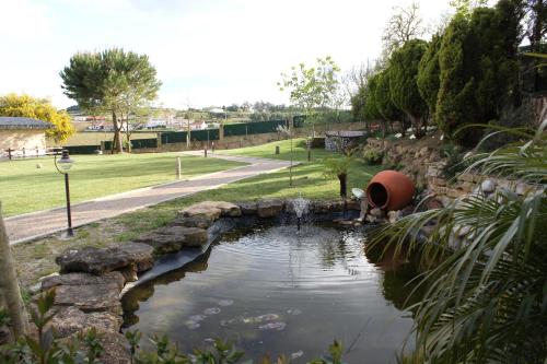 a pond in the middle of a park at Quinta Sobral Prestige - Rustic House in Sobral de Monte Agraço