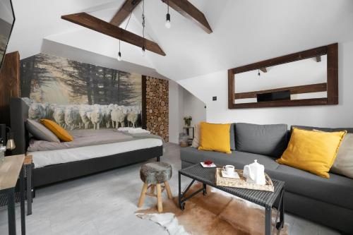 a living room with a couch and a table at Aparthotel Narciarska 2 in Korbielów