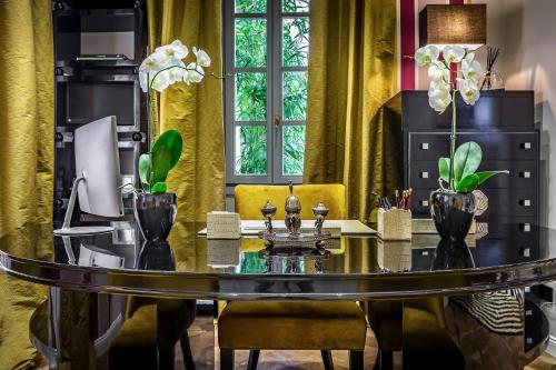 a dining room with a table and a yellow chair at Arte' Boutique Hotel in Florence