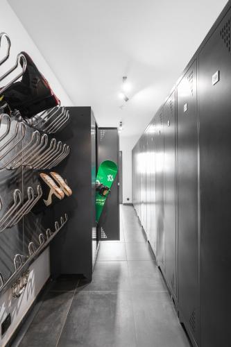 a hallway of a locker room with silver cabinets at Aparthotel Narciarska 2 in Korbielów