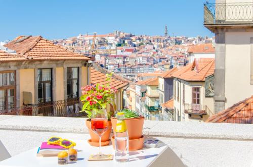 a table on a balcony with a view of a city at Porto Moments Apartments by Portugal Collection in Vila Nova de Gaia