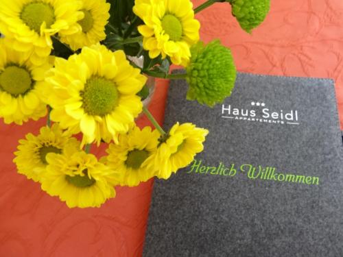 a bunch of yellow flowers in a vase at Haus Seidl in Bodenmais