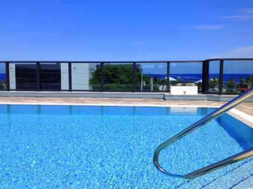 a swimming pool with a view of the ocean at Vistalmar Beach Resort in Deerfield Beach