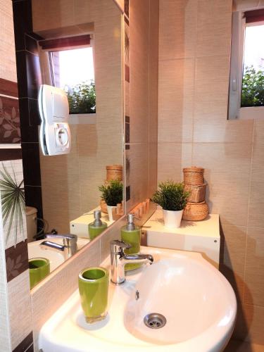 a bathroom with a sink and a mirror at Domki U Skrzata in Łeba