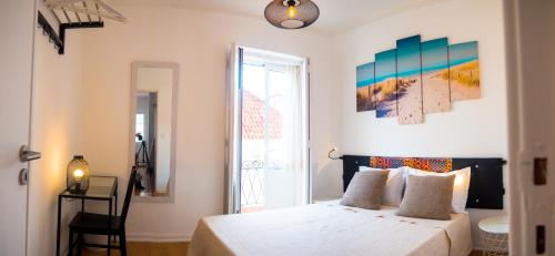 a bedroom with a white bed and a window at Alagoa Terrace Guesthouse in Faro