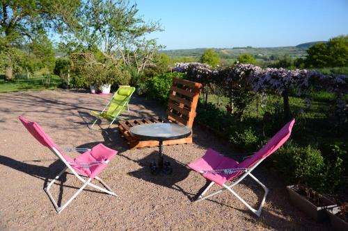 three chairs and a table and a table and chairs at Chambre d'hôtes Chez Léon pour 1 à 4 personnes in Chaulgnes