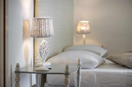 a bedroom with a bed with two lamps and a table at Amoredimare Casa Vacanze in Polignano a Mare