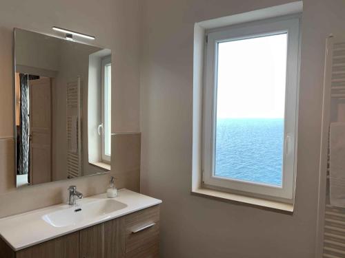 a bathroom with a sink and a window at Amoredimare Casa Vacanze in Polignano a Mare