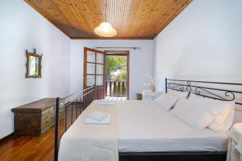 a bedroom with a large bed with a wooden ceiling at Villa Nina in Panagia