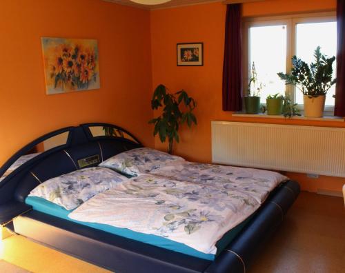 uma cama num quarto com uma parede laranja em Apartment Rappitsch em Sankt Marein bei Knittelfeld