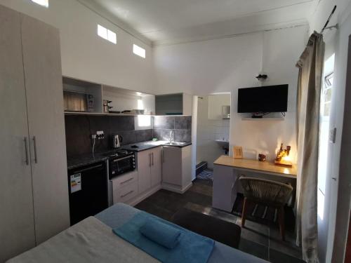 a small kitchen with a table and a counter top at The Beach Hide in East London