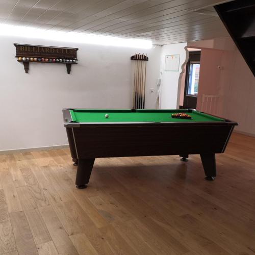 a pool table in the middle of a room at Ô Rethel Jacuzzi, Gîte Ardennes in Rethel
