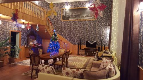 a living room with a christmas tree on the wall at Family holiday home. in Qusar