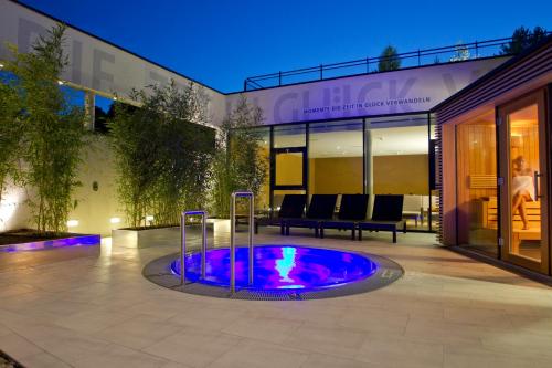 a swimming pool in the middle of a house at Hotel Stoiser in Loipersdorf bei Fürstenfeld