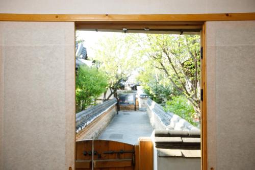 a sliding glass door with a view of a sidewalk at GaEunChae in Jeonju