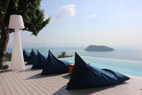 a row of umbrellas sitting on top of a beach at Bluerama - Adults Only in Haad Pleayleam