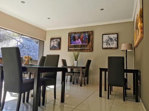 a dining room with a table and chairs at Aerotropolis Guest Lodge in Kempton Park