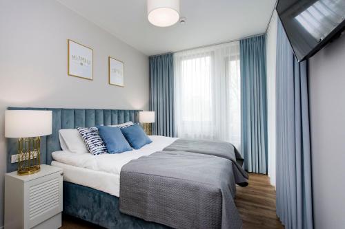 Säng eller sängar i ett rum på Blue Rentyear Apartments