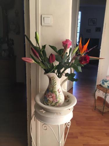 a vase filled with flowers sitting on a stand at Chez Mimi & Chouchou in Garéoult