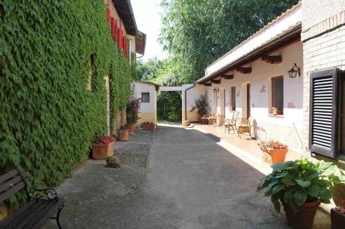 an alley with a bench next to a building at Agriturismo La Selva in Siena