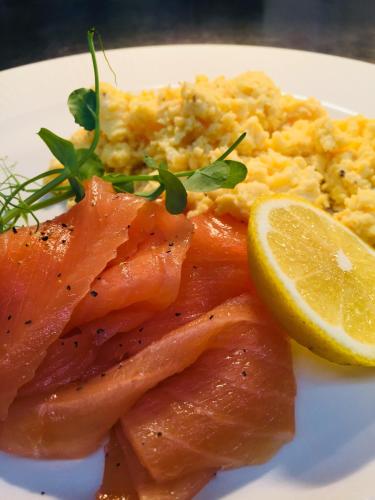 a plate of food with salmon and rice and a lemon at The Carpenters Arms in Thirsk
