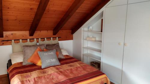 a bedroom with a bed and a wooden ceiling at Guest House La Sereine in Romanel-sur-Lausanne