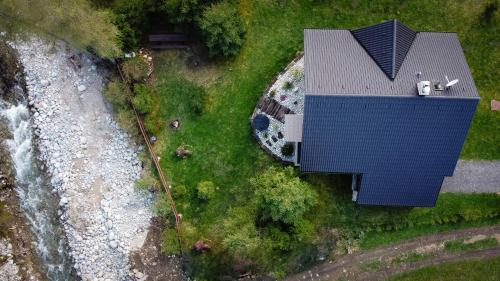 an overhead view of a house with a blue roof at Chata Lienka in Lazisko