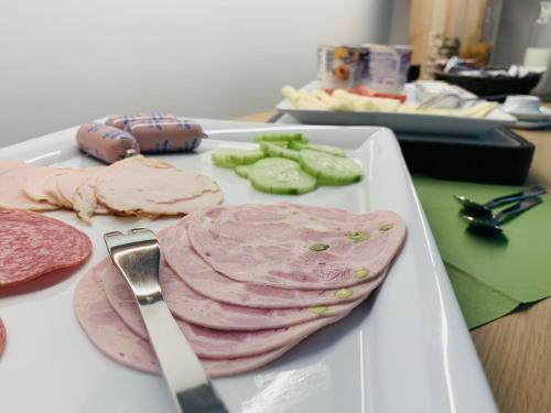 a plate of food with meat and a knife at Weingut Bugner Meizelhof in Klein-Winternheim