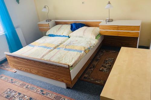 a bedroom with a bed and two dressers and a table at Ubytování NOVÁ in Kunžak