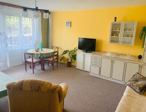 a living room with a table and a tv at Ubytování NOVÁ in Kunžak