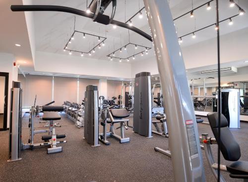 a gym with several treadmills and cardio machines at Coco View Hotel in Samut Songkhram