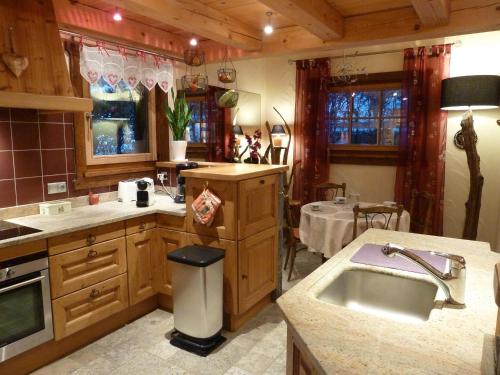 a large kitchen with a sink and a table at Chalet Kidou in Chamonix-Mont-Blanc