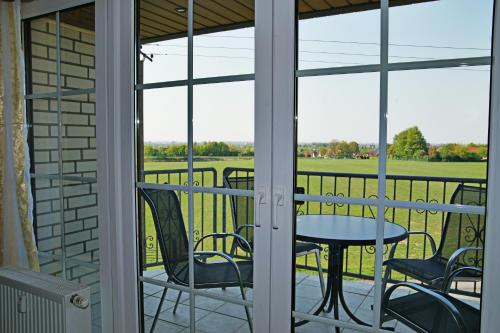 a patio with a table and chairs on a balcony at Ferienwohnung Bergblick Xanten in Xanten