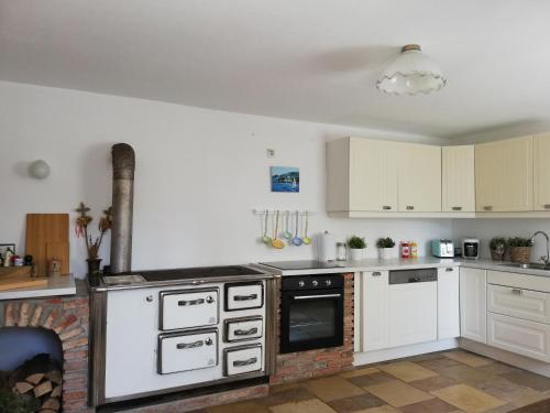 a kitchen with white cabinets and an oven at Fancy Luxury Home In Former Tavern in Gmunden